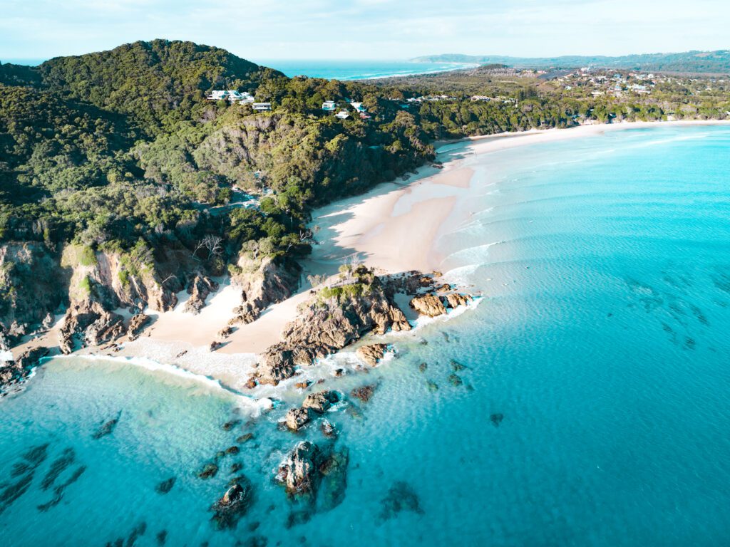 Aerial view of a beach at sunrise, waves and beautiful blue, turquoise water